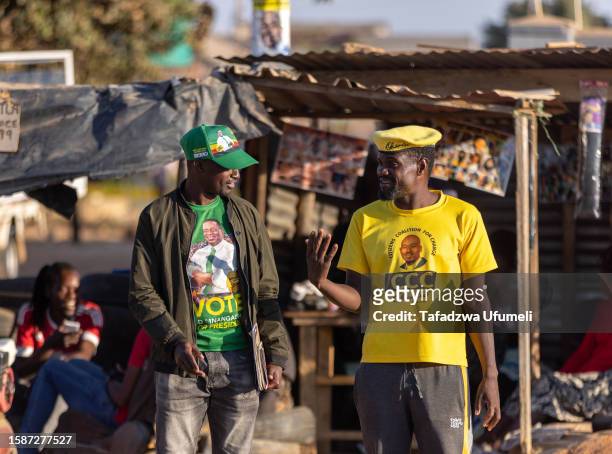 Supporter of the ruling party ZANU PF and a supporter of Citizens' Coalition for Change- talk in their respective party regalia during the country's...