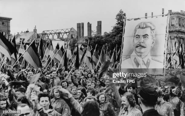 Soviet-sponsored youth rally in the Lustgarten in Berlin, Germany, 1st June 1950. The youth carry huge portraits of Communist leaders such as Joseph...