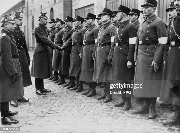 Or Schutzstaffel officers are sworn in as auxiliary police officers at Potsdam, Germany, 3rd March 1933.