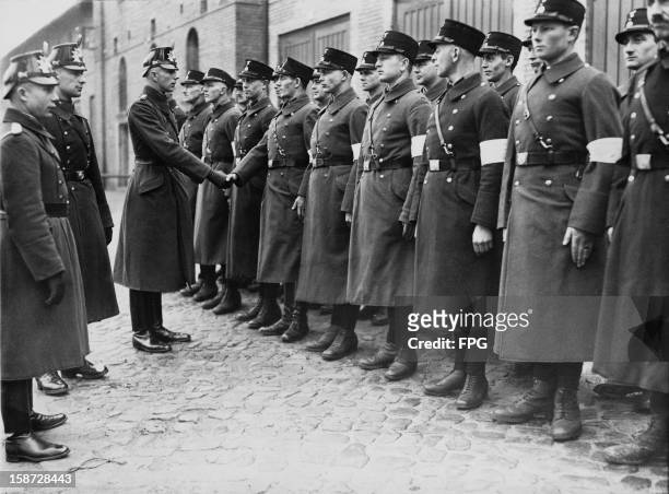 Or Schutzstaffel officers are sworn in as auxiliary police officers at Potsdam, Germany, 3rd March 1933.