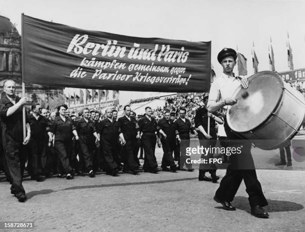 East Germany's Kriegsverträge or New Works Fighting Groups take part in the May Day parade in East Berlin, Germany, 9th May 1955.