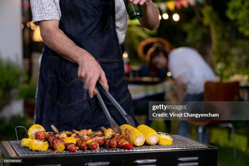 Barbecue grill at backyard with friends, enjoying weekend