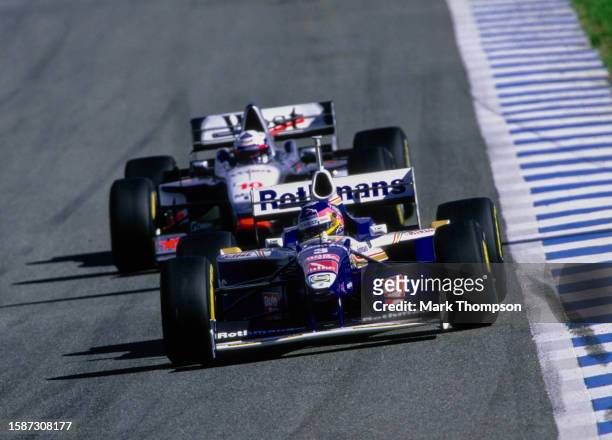 Jacques Villeneuve from Canada drives the Rothmans Williams Renault Williams FW19 Renault RS9 V10 ahead of David Coulthard of Scotland driving the...