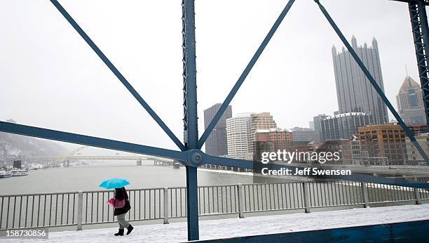 Pedestrian crosses the Smithfiled Street Bridge a winter storm blanketed the Midwest with snow December 26, 2012 in Pittsburgh, Pennsylvania. The...