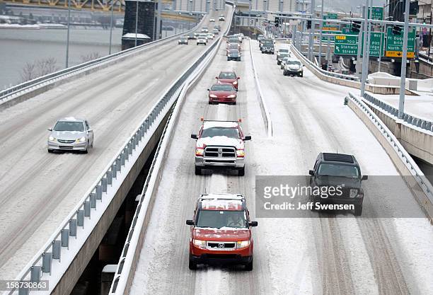 Commuters battle snow-covered roads after a winter storm blanketed the Midwest with snow December 26, 2012 in Pittsburgh, Pennsylvania. The storm has...