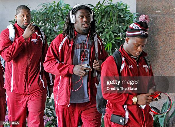 South Carolina's Corey Robinson, from left, defensive end Jadeveon Clowney and running back Shon Carson arrive at the Grand Hyatt Tampa Bay in Tampa,...