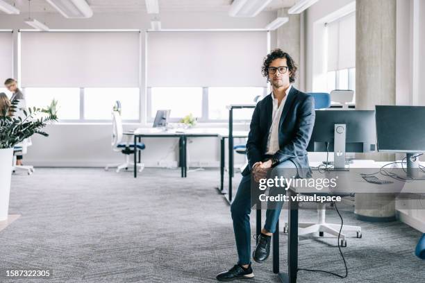 portrait of well dressed latin businessman at the office - business man sitting banking imagens e fotografias de stock