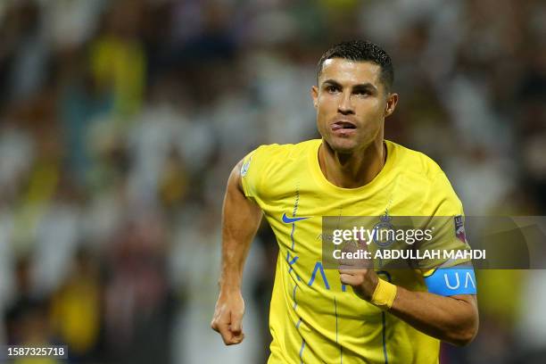 Nassr's Portuguese forward Cristiano Ronaldo reacts after scoring his team's first goal during the 2023 Arab Club Champions Cup semi-final football...