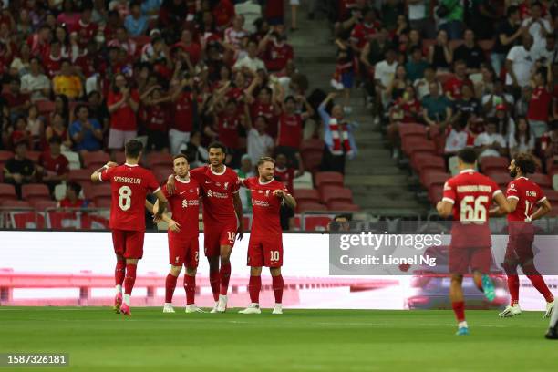 Liverpool celebrate their first goal during the pre-season friendly match between Liverpool and Bayern Muenchen at the National Stadium on August 02,...