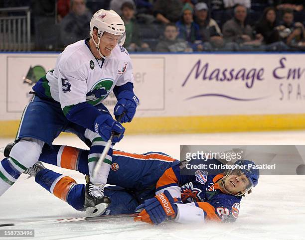 David Ullstrom of the Bridgeport Sound Tigers falls to the ice after being checked by Blake Parlett of the Connecticut Whale during an American...
