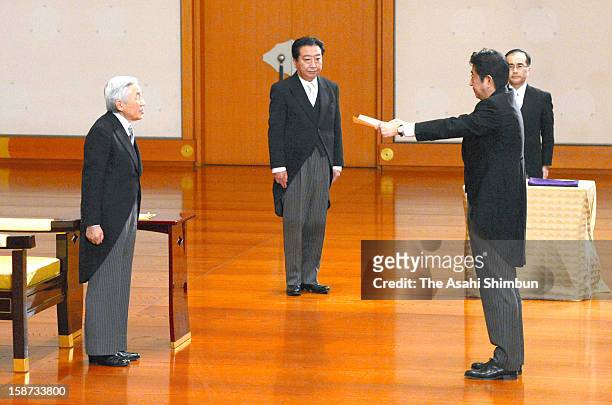 Emperor Akihito appoints Shinzo Abe as Japan's new prime Minister while predecessor Yoshihiko Noda observes at the Imperial Palace on December 26,...