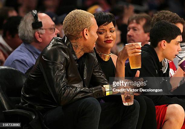 Recording artists Chris Brown and Rihanna attend the NBA game at Staples Center on December 25, 2012 in Los Angeles, California. The Lakers defeated...