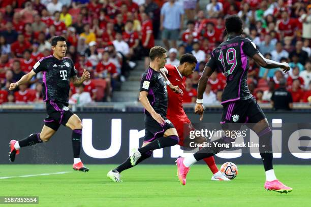 Cody Gakpo of Liverpool scores his team's first goal against Bayern Munich during the first half of the pre-season friendly at the National Stadium...