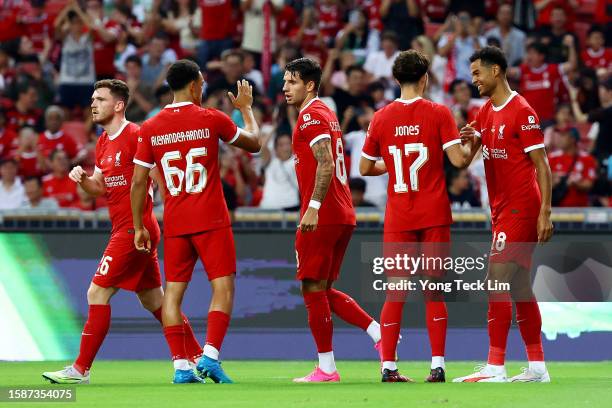 Cody Gakpo of Liverpool celebrates with teammates after scoring their first goal against Bayern Munich during the first half of the pre-season...
