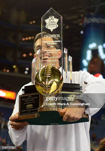 Head Coach Dan Enos of the Central Michigan University Chippewas holds up the Little Caesars Pizza Bowl Championship Trophy after the victory against...