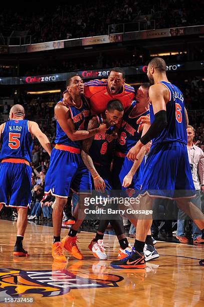 Smith of the New York Knicks celebrates a game winning basket against the Phoenix Suns with teammates James White, Carmelo Anthony, Steve Novak, and...