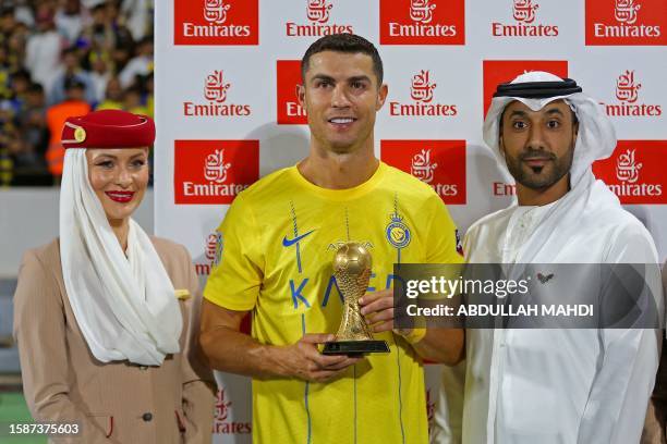 Nassr's Portuguese forward Cristiano Ronaldo poses with his top scorer trophy following the 2023 Arab Club Champions Cup semi-final football match...