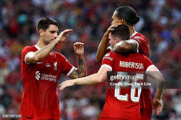 Virgil van Dijk of Liverpool celebrates with Dominik Szoboszlai and Andy Robertson after scoring their second goal off a header against Bayern Munich...