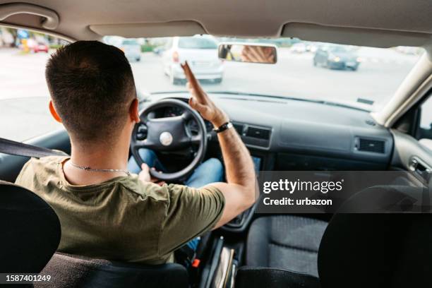 distressed and angry young man driving a car - taxi driver stock pictures, royalty-free photos & images