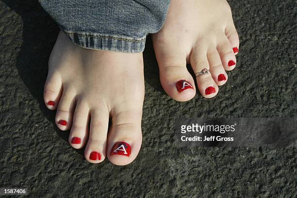 Mary Ciecek of Tustin, California displays her painted toes with Anaheim Angels colors and logos as she gets ready for game seven of the World Series...