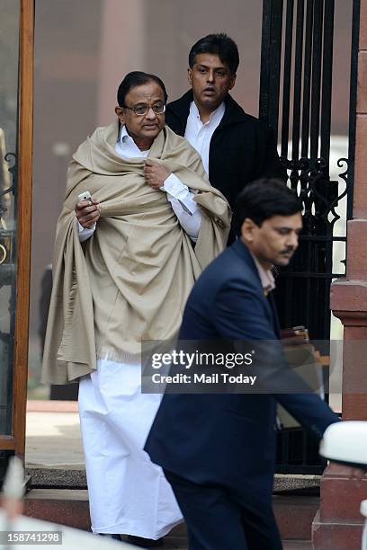 Union Finance Minister P Chidambaram and Information and Broadcasting Minister Manish Tewari leave after a Cabinet meeting at South Block in New...