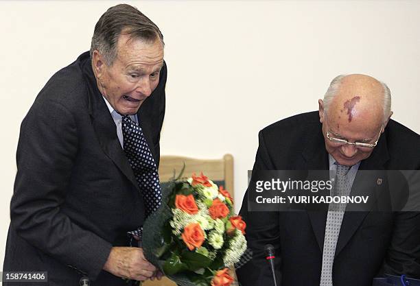 Former US President George Bush and the former Soviet leader Mikhail Gorbachev joke after a speech at the State Foreign Affairs University in Moscow...