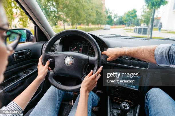 young woman having a driving lesson with a male driving instructor - driving test stock pictures, royalty-free photos & images