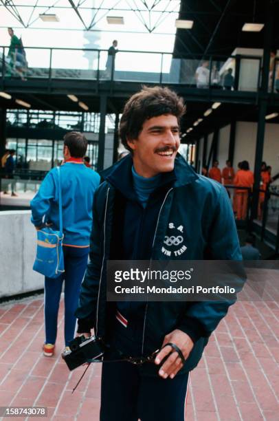 Great swimming champion and winner of seven gold olympic medals, the american Mark Spitz, is doing a tour into the Olympic village with his camera,...