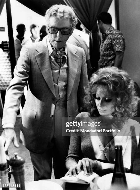Italian director Luciano Salce with Italian actress and singer Maria Grazia Buccella on the set of the film Basta Guardarla. Rome, 1970s