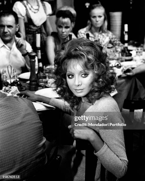 Italian actress and singer Maria Grazia Buccella sitting on the set of the film Basta Guardarla. Rome, 1970s