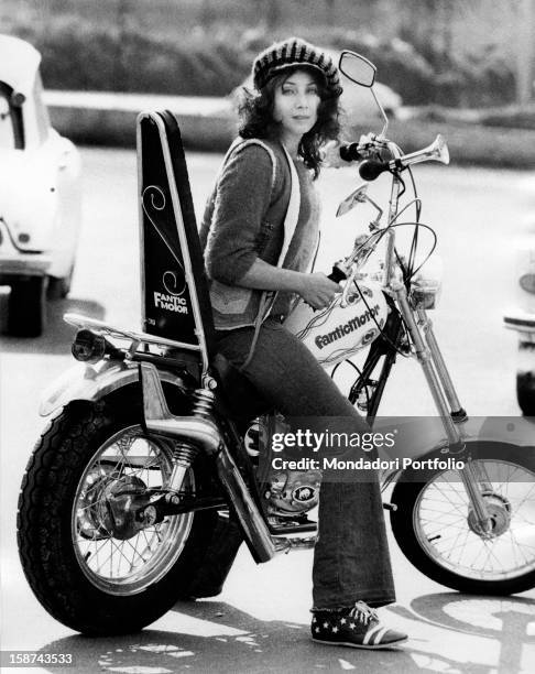 Italian actress and singer Maria Grazia Buccella sitting on a motorcycle. Rome 1970s