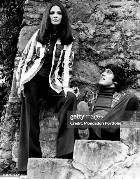 Gianni Morand with his wife, The Italian actress known as Laura Efrikian, on a stone staircase. Italy, 1972.