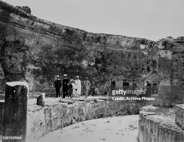 British Royals George V and Queen Mary walking in the Maritime theatre during a tour of the ruins of Hadrian's Villa near Tivoli, Italy, 14th May...