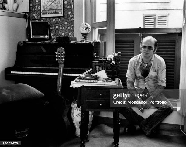 Italian musician and singer-songwriter Gino Paoli smokes a cigarette sitting in a room of his private house, surrounded by his musical instruments....