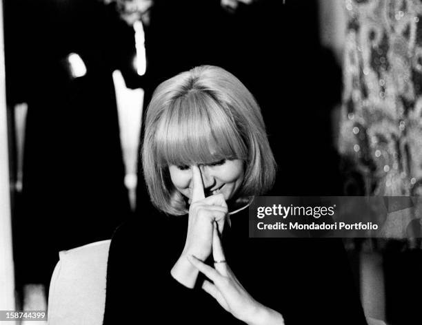 Italian actress and singer Carmen Villani laughing and covering her face with her hands. Milan, 1970s