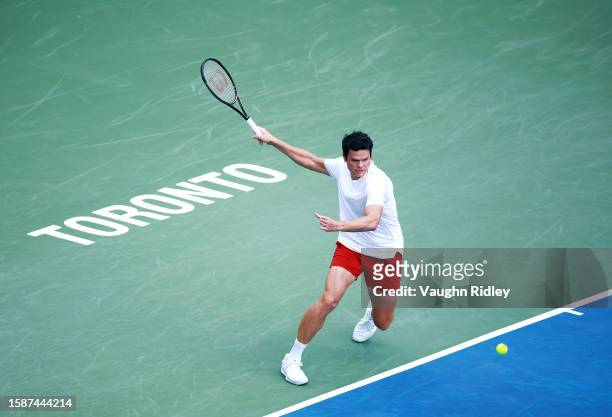 Milos Raonic of Canada hits a shot against Taro Daniel of Japan during Day Three of the National Bank Open, part of the Hologic ATP Tour, at Sobeys...