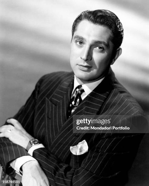 Portrait of the US actor Robert Alda wearing a pinstripe suit. USA, the '40s.