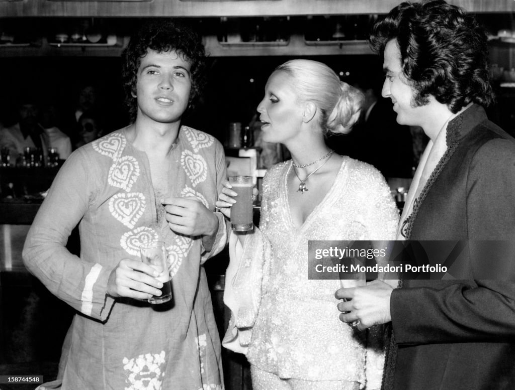Lucio Battisti, Patty Pravo and Little Tony have a drink during a pause from Festivalbar music competition