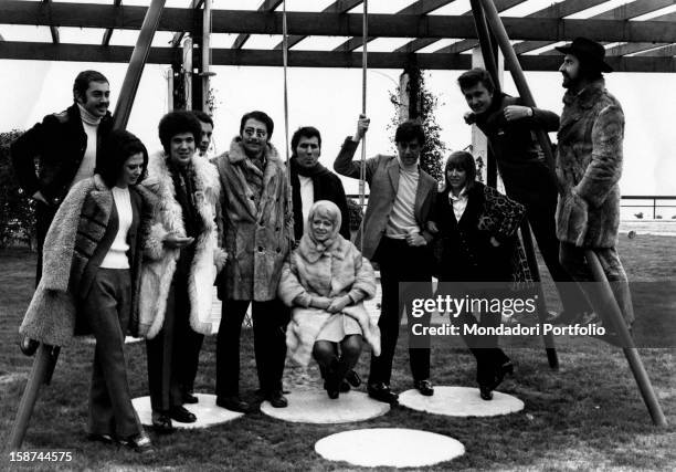 Many singers and musicians involved in Sanremo Music Festival are gathered in a group photo in a playground next to Sanremo beach; among them are,...