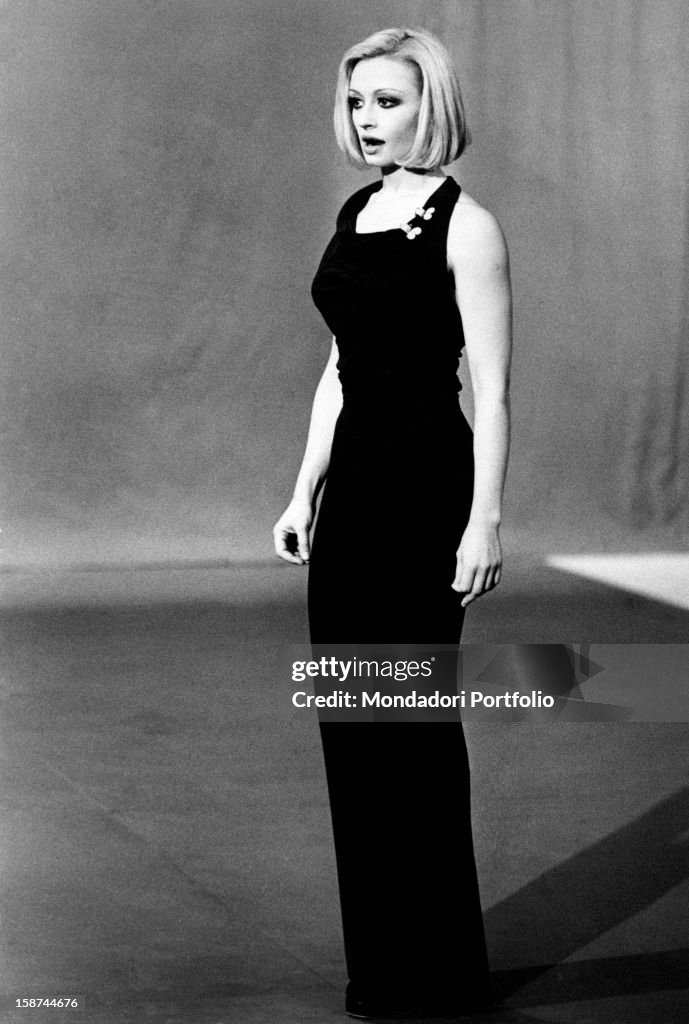 Raffaella Carrà in a dark evening dress