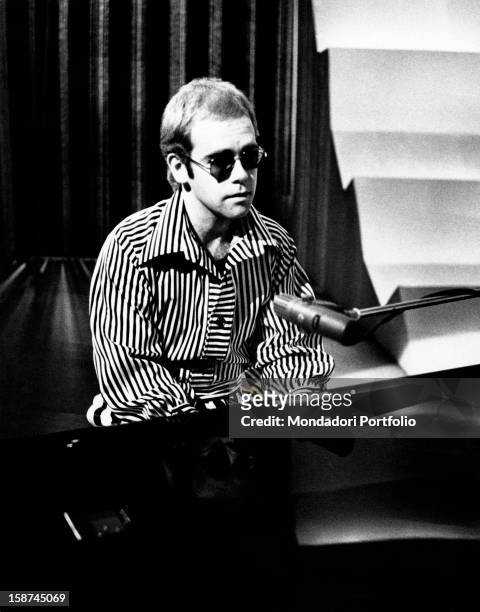 British singer, songwriter and musician Elton John playing piano. Rome, 1973