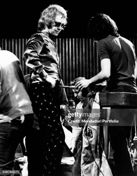 British singer, songwriter and musician Elton John with some members of his band during the rehearsal. Rome, 1974