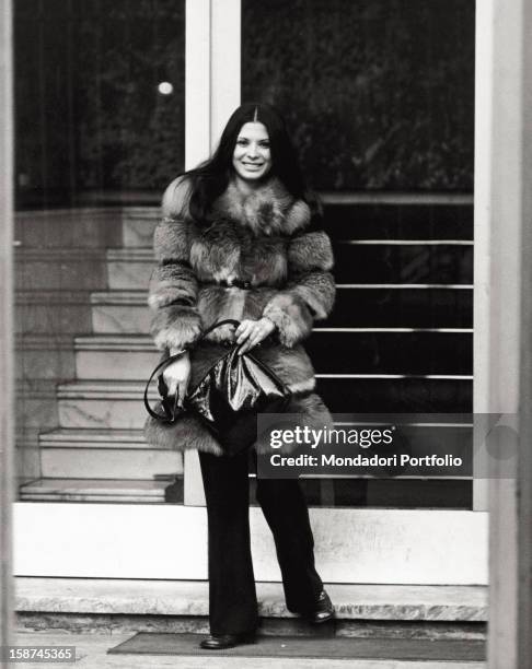 Portrait of the Italian singer and actress Rosanna Fratello in front of the entrance of Palazzo del Ghiaccio. Milan, 1972