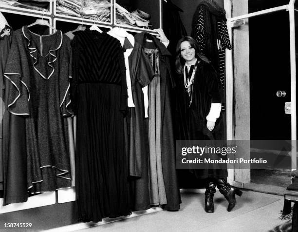 Italian actress and TV presenter Laura Efrikian smiling and leaning on a wardrobe. Rome, 1970s