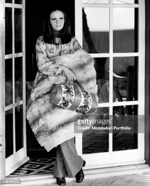 Italian actress and TV presenter Laura Efrikian wearing a fur stole. Rome, 1970s