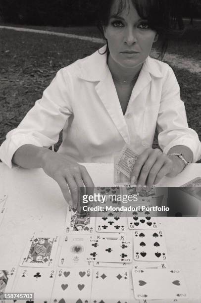 The Italian actress Lisa Gastoni playing cards patience. Italy, 1960s
