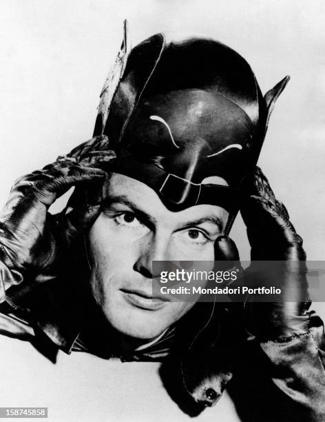 American actor Adam West putting on the mask of the comics superhero Batman in the TV serie Batman. 1966