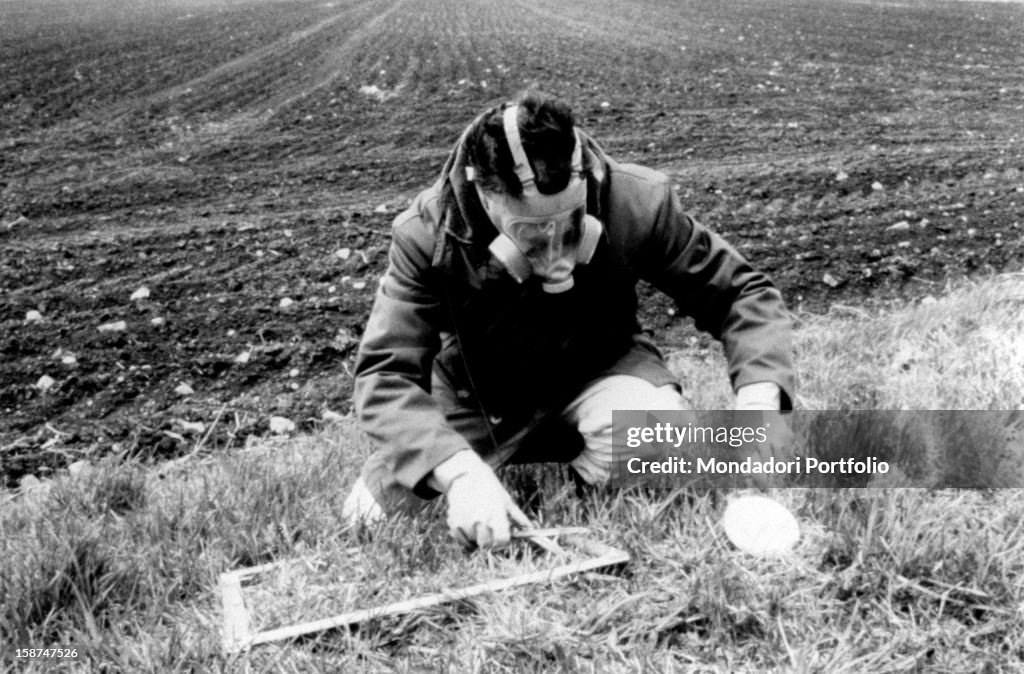 A man taking a sample from the ground