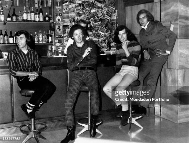 The Italian band Equipe 84 sitting on the stools at the bar. Italy, 1968