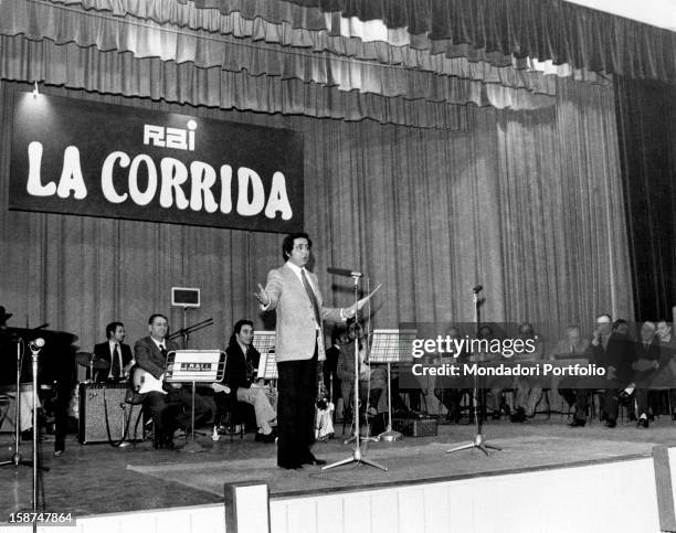 Italian TV host Corrado presenting the radio show La corrida. Rome, 1970s